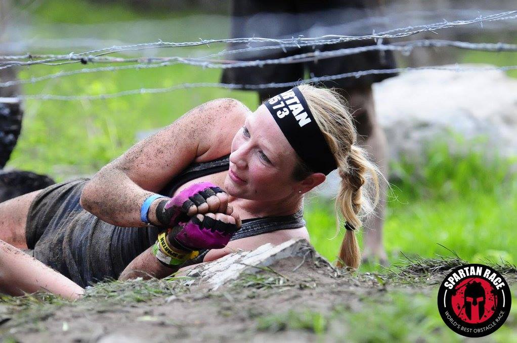 Heather going under the barbed wire at the Spartan Beast